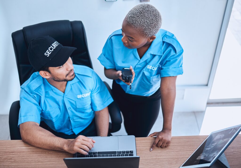 Security guard, safety officer and team in office with a laptop and walkie talkie for surveillance.